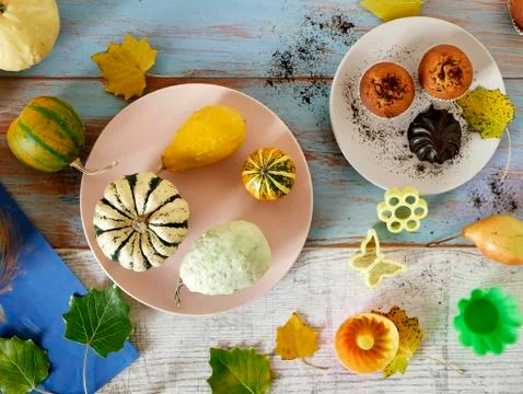 Autumn composition of pumpkins of different varieties, cupcakes, pears Stock Photos