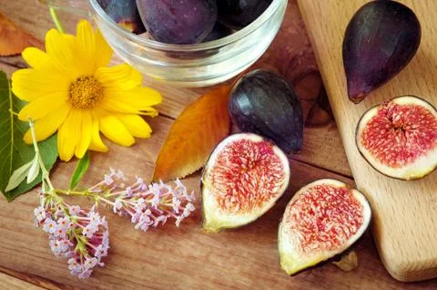 Autumn composition - ripe figs and flowers. Ripe sweet figs . Healthy Stock Photos