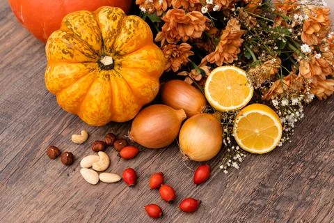 Autumn composition. On the table are pumpkins, onions, nuts, rose hips. Cooking Stock Photos