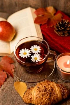 Autumn composition, tea, pumpkins, candle on the table. Autumn comfort at hom Stock Photos