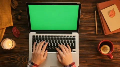 Autumn concept with tea cup, candle, notebook, laptop computer with green screen Stock Footage 80804867