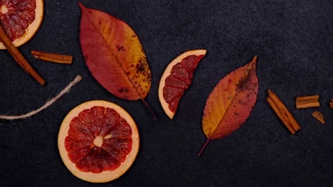 Autumn dark background or composition with candied, dried oranges, cinnamon and Stock Footage 168515885