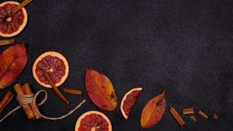 Autumn dark background or composition with candied, dried oranges, cinnamon and Stock Footage 169388034