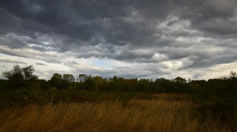 Autumn dark clouds , field  dry grass, time lapse, quick motion Stock Footage 45838678