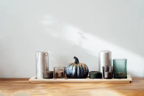 Autumn, fall cozy composition. Gray pumpkin with sequins and burning candles on Stock Photos