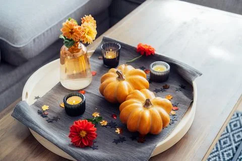 Autumn, fall cozy mood composition for hygge home decor. Small pumpkins, burning Stock Photos