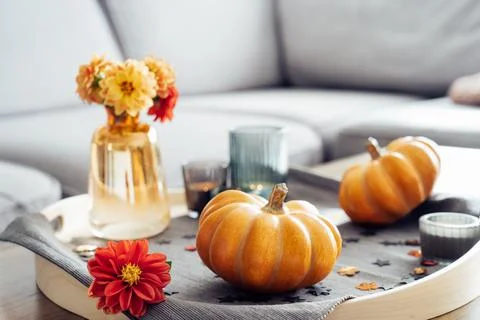 Autumn, fall cozy mood composition for hygge home decor. Small pumpkins, burning Foto stock