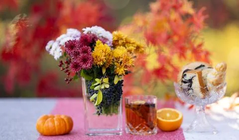 Autumn fall decor with mulled wine, books, cookies and flowers. Cozy fall Stockfoto's