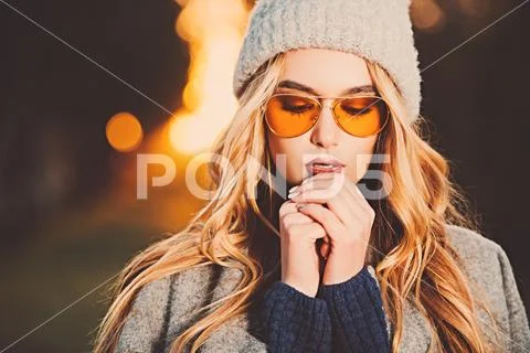 Autumn fashion. Fashionable young woman wearing warm sweater, a coat and a wo Stock Photos
