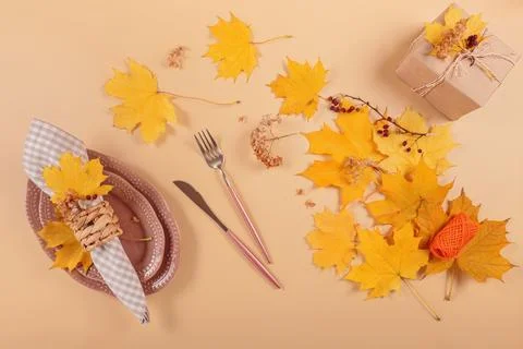 Autumn festive table setting on beige background Stock Photos