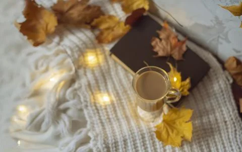 Autumn flat lay composition. Warm comfort white sweater, book, coffee cup, dr Foto stock