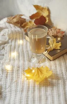Autumn flat lay composition. Warm comfort white sweater, book, coffee cup, dr Stock Photos