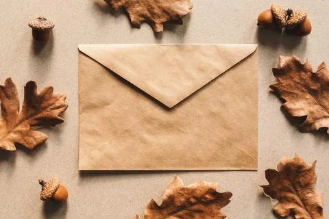 Autumn flat lay, fall background with kraft paper envelope and oak leaves Stock Photos