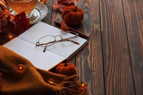 Autumn flat lay with warm tea, notebook, and fall decorations Stock Photos