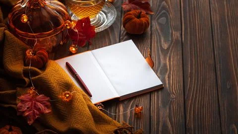 Autumn flat lay with warm tea, notebook, and fall decorations Stock Photos