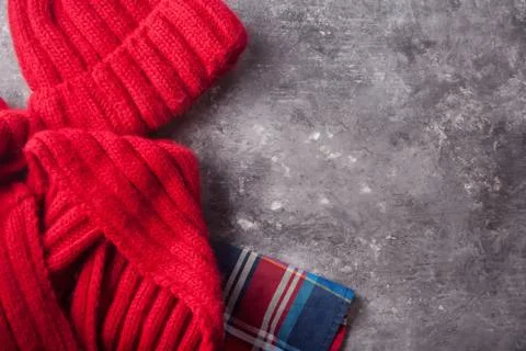 Autumn flatlay composition. Frame of red scarf, skirt, cap on concrete backgr Stock Photos