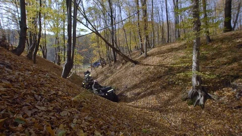 Autumn forest. The man in a special form on the ATV. The racer rides on the wood Video stock 104010882