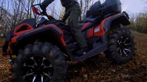Autumn forest. The man in a special form on the ATV. The racer rides on the wood Video stock 104061114