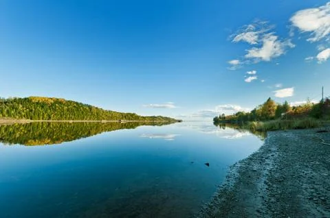 Autumn forest reflection in the ocean Stock Photos