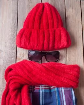 Autumn funny flatlay composition. Red scarf, skirt, cap and sunglasses on the Stock Photos