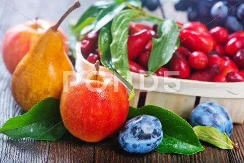 Autumn harvest on the wooden table, autumn fruits Stock Photos