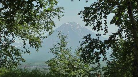 The autumn here comes when this volcano starts to grow white from above Видео 8557654
