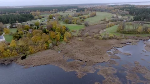 Autumn Landscape with Marshland and Patchwork Fields Under Overcast Sky Stock Footage 296570062