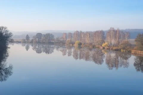 Autumn landscape. Reflection of trees in a river Stock Photos