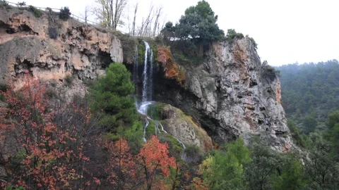 Autumn landscape of waterfall while it rains. Video stock 143973180