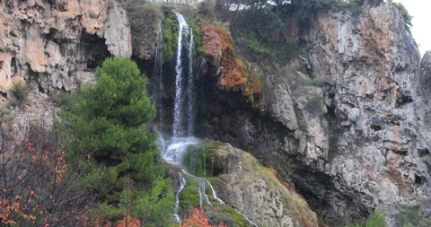 Autumn landscape of waterfall while it rains in 4K. Video stock 143975463