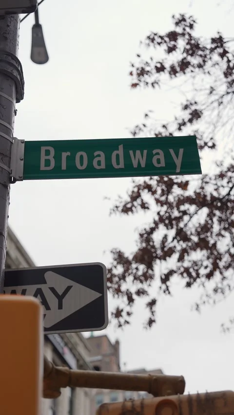 Autumn Leaves Framing Lamp Posts And Signs, Actor Rushing Past Vintage Theater Stock Footage 323774064