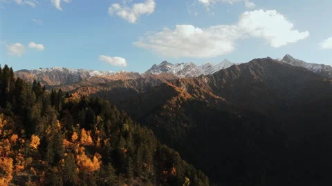 Autumn Mountain Landscape with Forested Ridges and Snowy Peaks Video stock 323557002