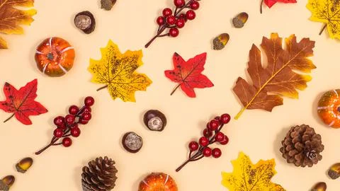 Autumn pattern with nuts and leaves on beige background. Creative fall backgr Stock Photos