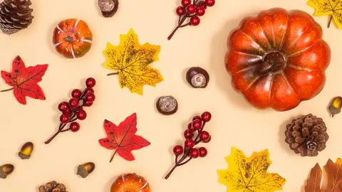 Autumn pattern with nuts pumpkins and leaves on beige background. Creative fa Fotos de archivo