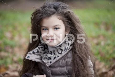 Autumn portrait of a beautiful little girl Stock Photos
