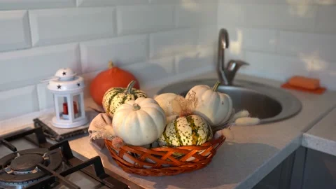 Autumn pumpkin in basket on the kitchen table with sun rays Stock Footage 162211470