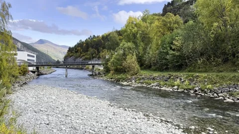 Autumn river flows under the bridge in Norway Stock Footage 318371421