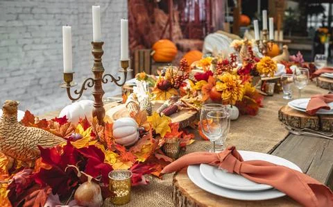 Autumn rustic table setting decorated with pumpkins and autumn leaves for cel Stock Photos