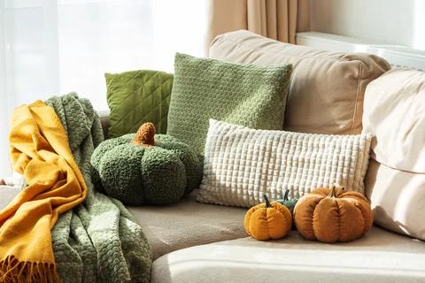 Autumn Sofa Styling with Textured Pillows, Fabric Pumpkins, and Cozy Blankets Stock Photos