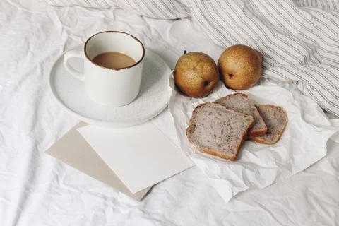 Autumn, summer breakfast in bed composition. Cup of coffee, pear fruit still 写真素材