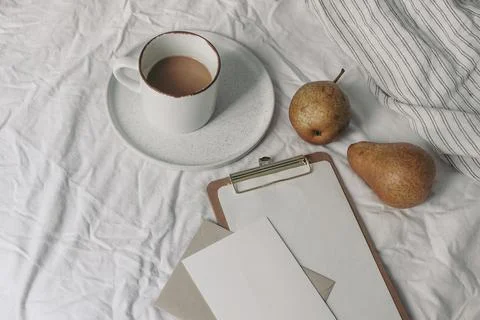 Autumn, summer breakfast in bed composition. Cup of coffee and pear fruit on Фото