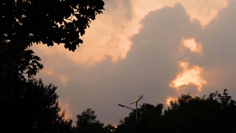 Autumn sunset light breaking through thick clouds over a park at dusk Stock Footage 342027973