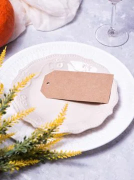 Autumn table setting with a brown craft paper card. Stock Photos
