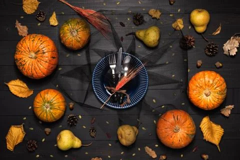 Autumn table setting with empty blue plate and pumpkins. Halloween or thanksg Stock Photos