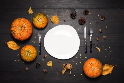 Autumn table setting with empty white plate and pumpkins. Halloween or thanks Stock Photos
