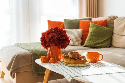 Autumn Table Setting with Pumpkin Shaped Buns with Cinnamon and Cup of Tea Fotos de archivo