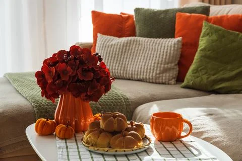 Autumn Table Setting with Pumpkin Shaped Buns with Cinnamon and Cup of Tea Stock Photos
