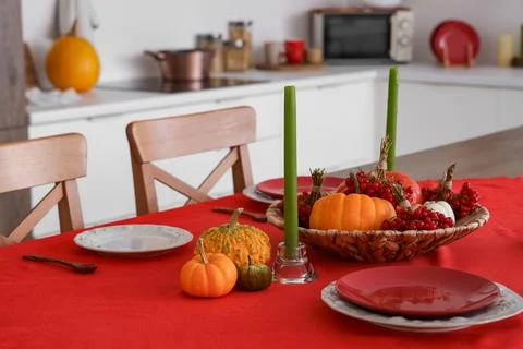 Autumn table setting with pumpkins and viburnum in kitchen Stock Photos