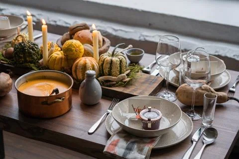 Autumn table setting with pumpkins. Thanksgiving dinner and fall decoration. Stock Photos