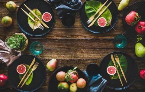 Autumn table styling with black dinnerware and leaves for decoration Stock Photos